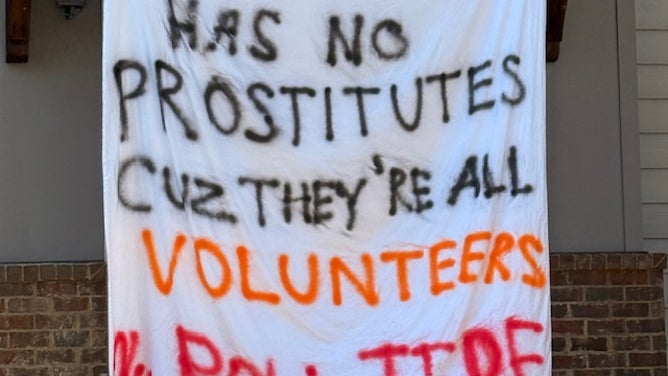 Alabama students hang signs outside their houses before the Tennessee game on Saturday night. 