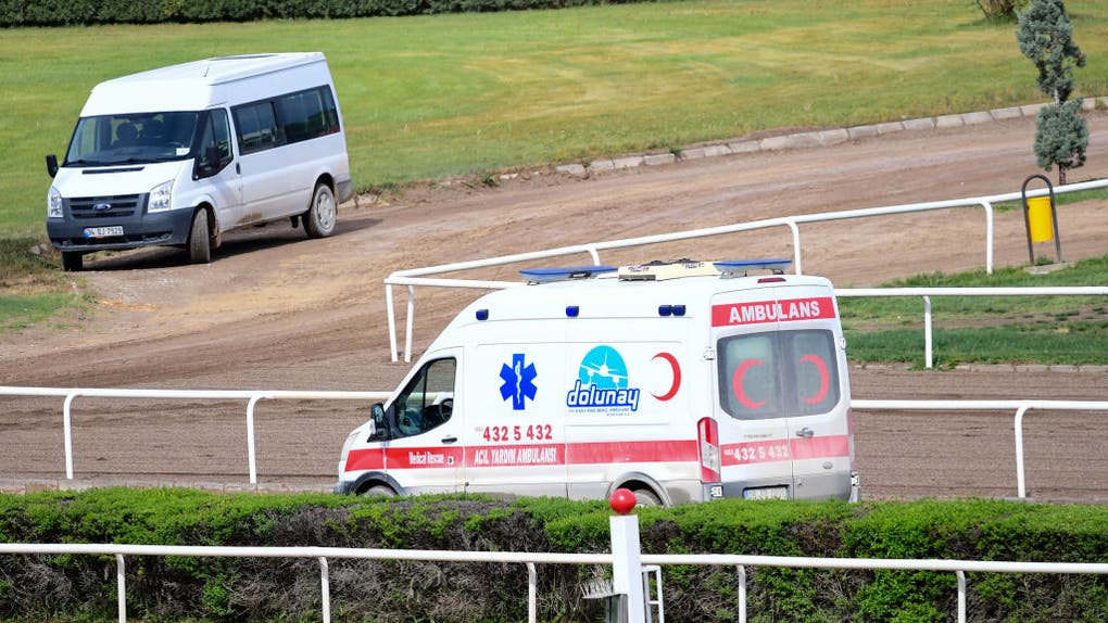 Ambulance on horse track middle of race