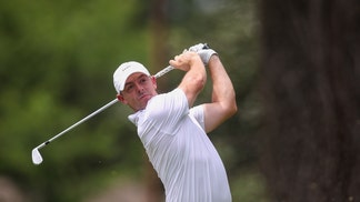 Rory McIlroy swinging an iron