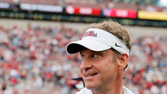 Lane Kiffin smiling at the crowd