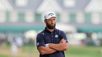 jon rahm with his arms crossed
