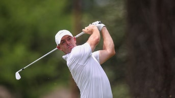 Rory McIlroy swinging an iron