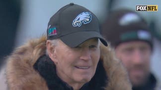 Former President Joe Biden on the sideline at Lincoln Financial Field wearing a Phildelphia Eagles hat. 