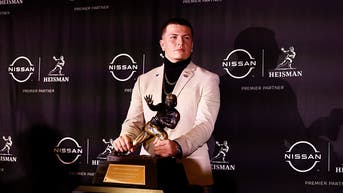 Diego Pavia with the Heisman Trophy