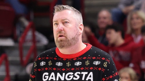 Queens basketball coach Grant Leonard wearing an awesome Christmas sweater