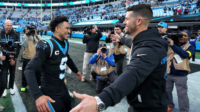 Carolina Panthers head coach Dave Canales celebrates with quarterback Bryce Young after a game against the Tampa Bay Buccaneers at Bank of America Stadium.