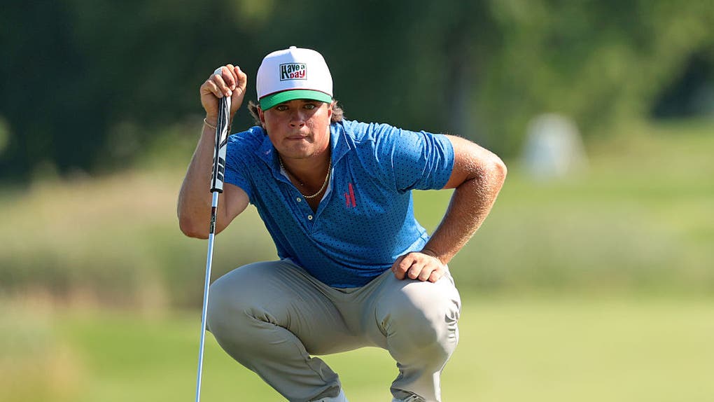 Michael La Sasso reading a putt on the green