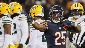 Chicago Bears running back Kyle Monangai (25) gestures toward the Green Bay Packers end zone after running for a first down.