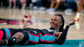 Ja Morant on the floor, laughing.