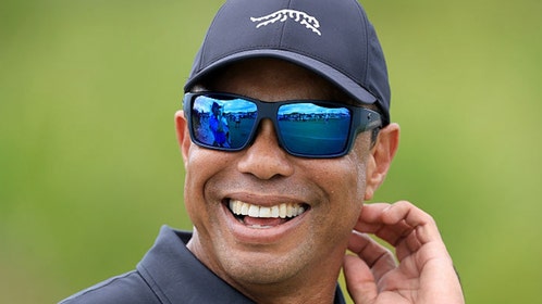 Tiger Woods in Sun Day Red, laughing