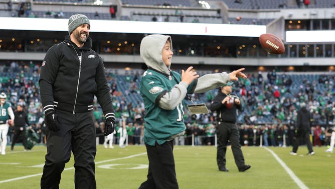 Head coach Nick Sirianni of the Philadelphia Eagles watches his son, Jacob, play catch before the NFC Wild Card Playoff game against the San Francisco 49ers at Lincoln Financial Field on January 11, 2026 in Philadelphia, Pennsylvania. 