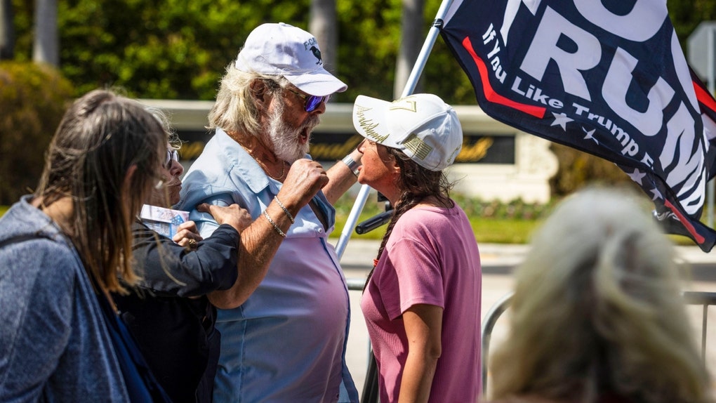 Let's go down to West Palm Beach, Florida, where an anti-Trump protester managed to beat a woman with a flagpole outside of Trump International. 