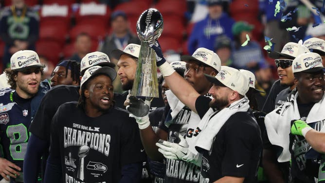 Seattle Seahawks' players celebrate with the Vince Lombardi Trophy after defeating the New England Patriots during Super Bowl LX at Levi's Stadium.
