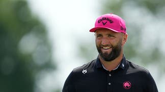 jon rahm smiling at a liv golf event
