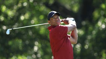 Tiger Woods hitting an iron at the Masters
