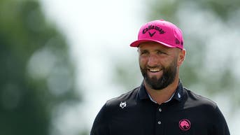 jon rahm smiling at a liv golf event