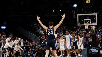 UConn Huskies guard Braylon Mullins (24) celebrates after making the game-winning three-point basket against the Duke Blue Devils in the second half during an Elite Eight game of the East Regional of the men's 2026 NCAA Tournament at Capital One Arena.