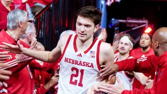 Nebraska Cornhuskers forward Pryce Sandfort (21) runs onto the court while being greeted by alumni players before the game against the Northwestern Wildcats at Pinnacle Bank Arena.