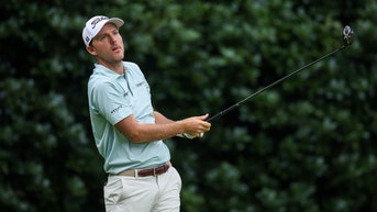 Russell Henley hitting a driver