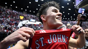 St. John's Red Storm guard Dylan Darling (0) celebrates after defeating the Kansas Jayhawks in the second half during a second round game of the men's 2026 NCAA Tournament at Viejas Arena. 