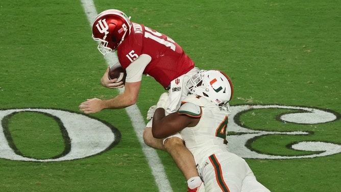 Miami Hurricanes defensive lineman Rueben Bain Jr. (4) sacks Indiana Hoosiers quarterback Fernando Mendoza (15) in the third quarter during the College Football Playoff National Championship game at Hard Rock Stadium. Mandatory Credit: Kim Klement Neitzel-Imagn Images