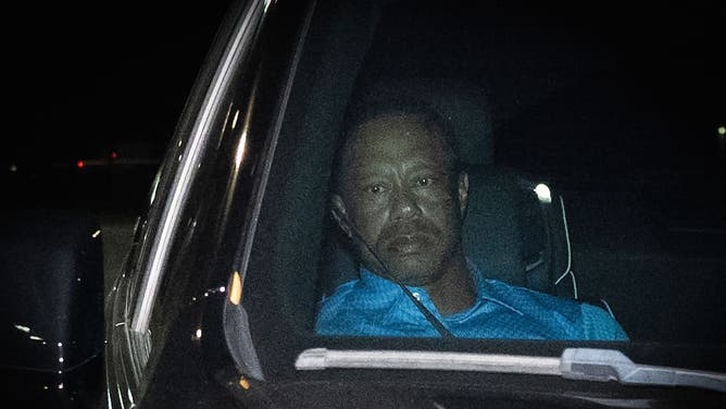 Tiger Woods sitting in an SUV after being released from prison following suspicion of DUI charge
