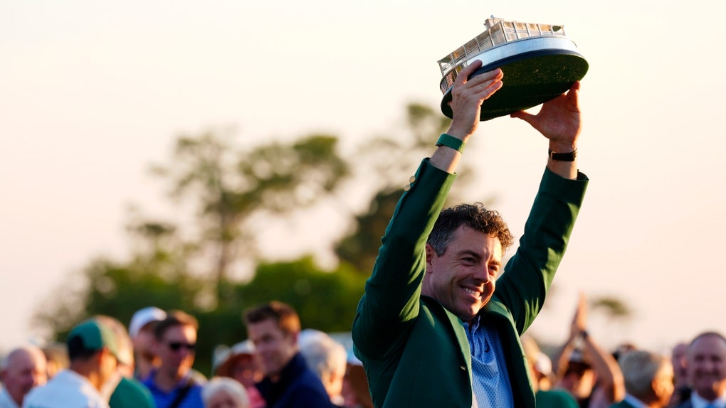 Rory McIlroy hoists the Masters trophy in 2026