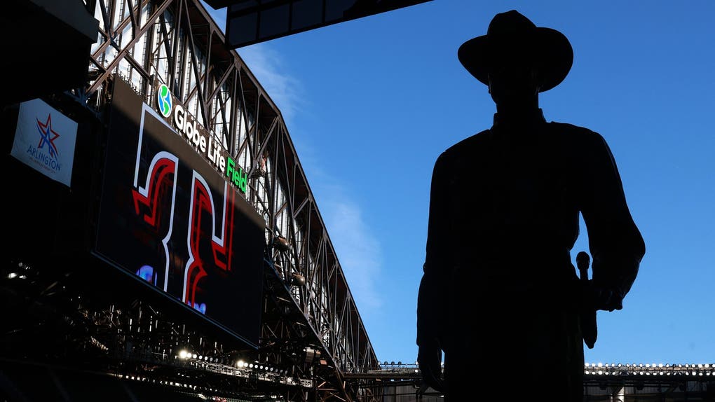 The "One Riot, One Ranger" statue is silhouetted by the sky visible from the open roof of Globe Life Field before a game between the Texas Rangers and Seattle Mariners at Globe Life Field on April 06, 2026.