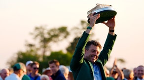 Rory McIlroy hoists the Masters trophy in 2026