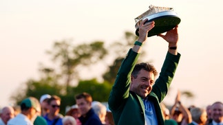 Rory McIlroy hoists the Masters trophy in 2026