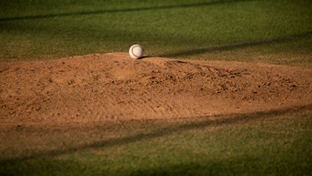 A baseball sitting on top of a mound