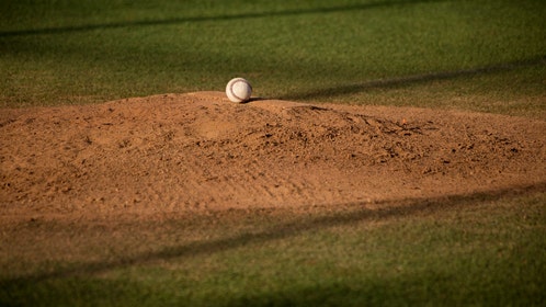 A baseball sitting on top of a mound